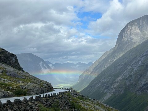 Rainbow above steep valley landscape and Trollstigen road, Rauma, M&oslash;re og Romsdal, Norway, August 2025
