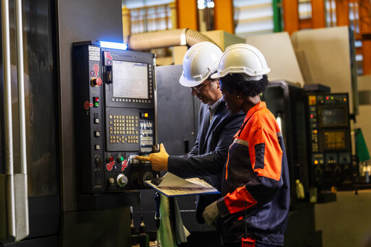 CNC Machine Operation Training with Factory Workers at Control Panel