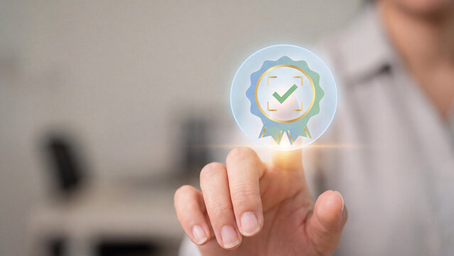 Quality assurance and certification concept, businessman touching virtual award badge icon with green check mark for quality control standard, guarantee approval and business service excellence