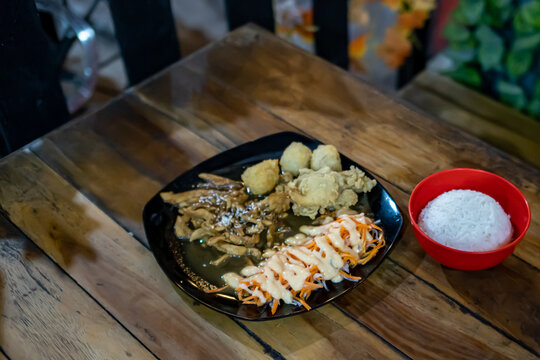 Crispy Fried Chicken with Creamy Sauce Salad and White Rice on Dark Plate