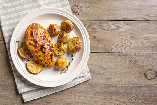 Oven roasted lemon garlic chicken and baby potatoes on plate