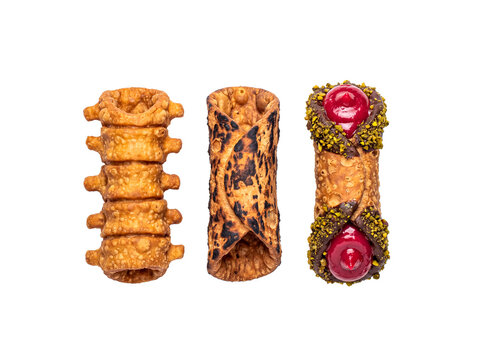 Three distinct Halloween-themed cannoli pastries, featuring bone-like, charred, and pistachio-cherry designs.
