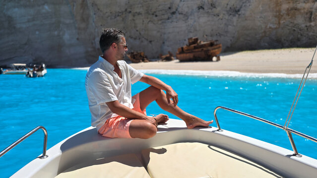 Relaxing on a boat at Navagio Beach, Zakynthos, Greece