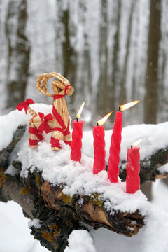 straw Yule Goat and burn red candles on snowy tree in winter forest. festive decor, traditional symbol of Scandinavian, Northern European Yule, Christmas holiday. witchcraft, magic ritual for Yuletide