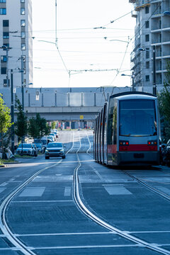Tram follows tracks along a residential urban street in Nordbahnviertel Vienna Austria showing public transport mobility within a modern neighborhood