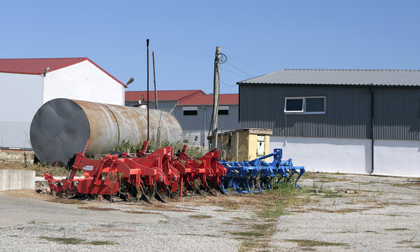 Agricultural plows and cultivators storing at farm warehouse