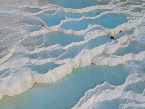 Spectacular travertine terraces of Pamukkale in Turkey attract travelers from around the world