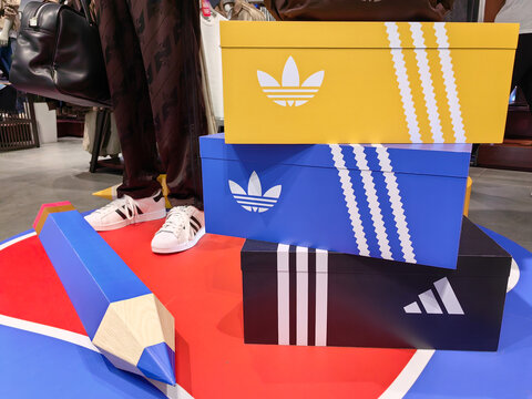 Almaty, Kazakhstan &ndash; August 20, 2026: Stacked Adidas shoeboxes with sneakers on a retail display floor.