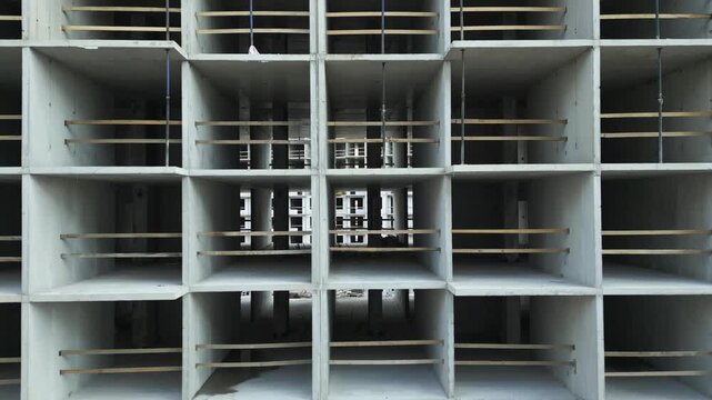 Unfinished multistory concrete building aerial view from bottom to top