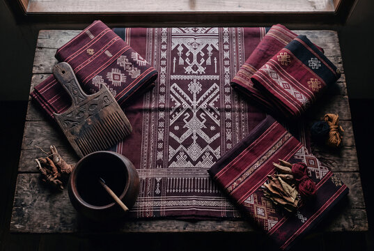 Batak ulos traditional woven fabric flat lay with wooden weaving comb and traditional patterns, authentic North Sumatra cultural textile for heritage brand and ethnographic marketing