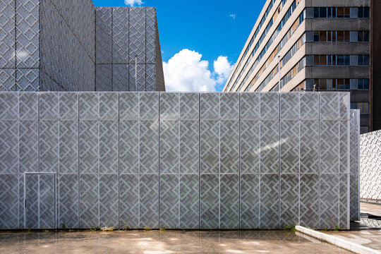 Facade pattern and architecture create abstract urban geometry with wall textures blue sky and bright exterior surfaces around contemporary buildings
