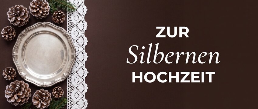 Silver wedding anniversary German banner with vintage tray, pinecones and white lace on dark brown background for 25th celebration greeting card template, festive winter invitation, copy space backgro