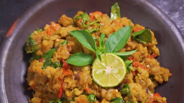 Tilt up view of traditional Indonesian sambal tempe in a mortar