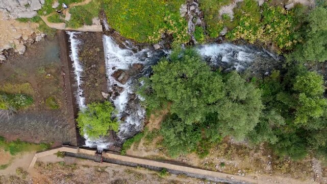 Rugged terrain flows with a clear, rushing stream (Munzur Gozeleri Ovacik Tunceli)