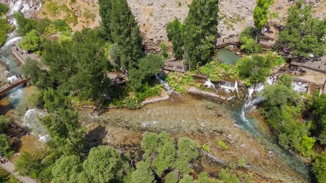 Rugged terrain flows with a clear, rushing stream (Munzur Gozeleri Ovacik Tunceli)