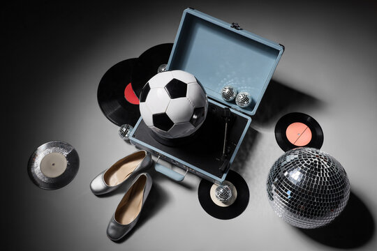 Party lifestyle and sports entertainment, soccer ball on vintage record player with disco ball and vinyl records for music and leisure event