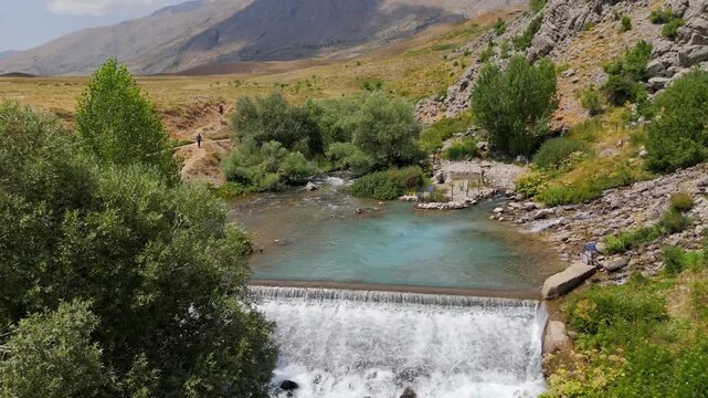 Rugged terrain flows with a clear, rushing stream (Munzur Gozeleri Ovacik Tunceli)