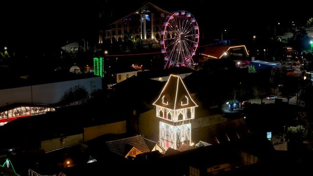 Night View Of Capivari Village In Campos Do Jordao In Sao Paulo Brazil. Illuminated Ferris Wheel. Downtown Cityscape. European Architecture. Capivari Village In Campos Do Jordao In Sao Paulo Brazil.