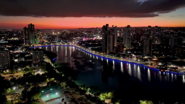 Sunset Lakefront Park In Campina Grande In Paraiba Brazil. Illuminated Lake. Downtown District. Lakefront Park In Campina Grande In Paraiba Brazil. Highrise Buildings Scenery. Sunset Sky Landscape.