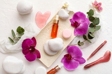 Obraz premium Skincare and wellness routine, facial massage tools with essential oil and orchid flowers for spa treatment and natural beauty self care at home