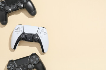 Gaming culture and entertainment video game controllers on a beige background with copy space for esports digital leisure and interactive media © Pixel-Shot