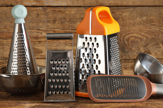 Food preparation and cooking tools, collection of metal kitchen graters and stainless steel utensils on a rustic wooden table for culinary projects