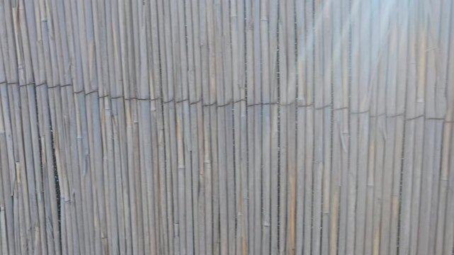 bamboo mat texture, brown reeds moving from side to side texture background at sunlight video