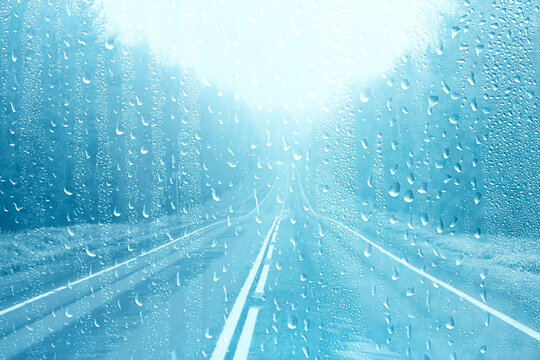 Wet car glass, autumn rain on the road, drops on the glass