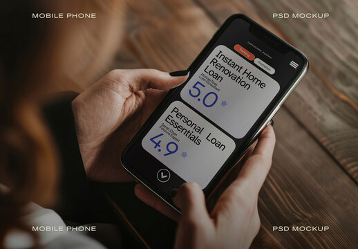 Hands Holding Smartphone Mockup PSD With App Screen On Wooden Table