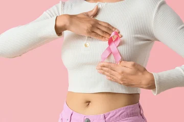 Fotobehang Onderzeeër Woman with pink ribbon on color background, closeup. Breast cancer awareness concept  © Pixel-Shot