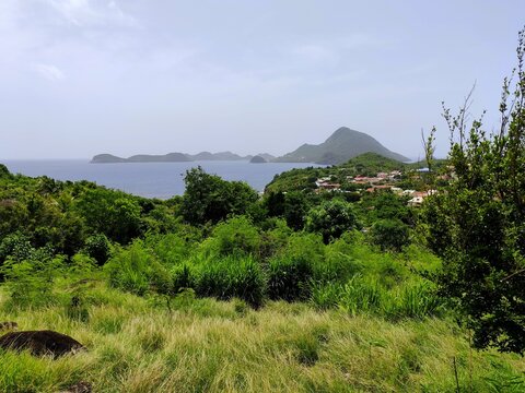 aerial view above Terre de Bas, over the Saintes islands in Guadeloupe archipelago, french west indies. Sky colors due to saharan dust