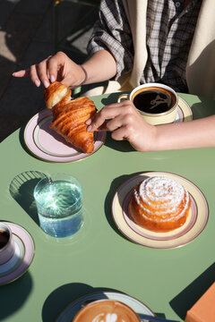 Couple Having Coffee and Fresh Croissants at Outdoor Cafe Table