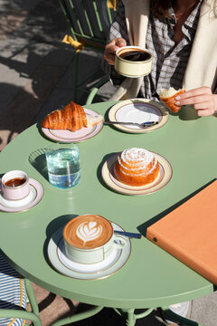 Couple Having Coffee and Fresh Croissants at Outdoor Cafe Table