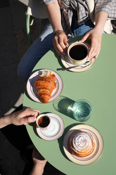 Couple Having Coffee and Fresh Croissants at Outdoor Cafe Table
