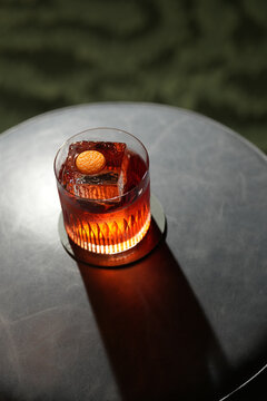 Classic Negroni Cocktail with Large Ice Cube and Orange Peel Garnish