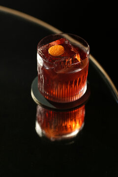 Classic Negroni Cocktail with Large Ice Cube and Orange Peel Garnish