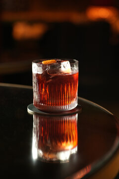 Classic Negroni Cocktail with Large Ice Cube and Orange Peel Garnish