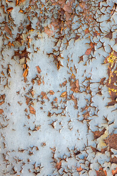 Cracked Gray Paint Peeling from a Rusty Metal Surface
