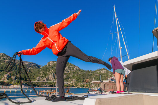 Woman sitting on bow of the yacht during sailing