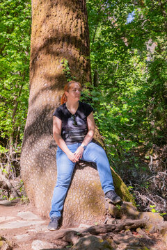 Travel Woman happy in a park spring near water