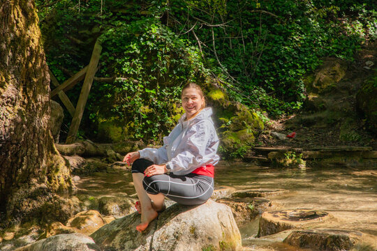 Travel Woman happy in a park spring near water