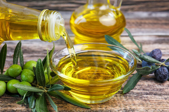 Organic olive oil pouring in a glass bowl	