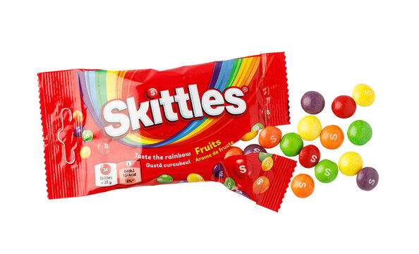 Skittles fruit candies spilling from a red package