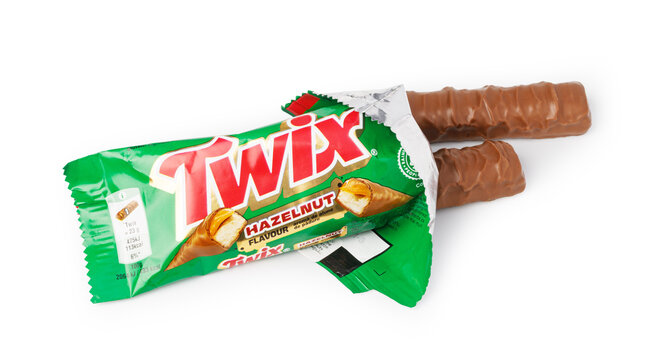 Twix hazelnut chocolate bar with open wrapper on white