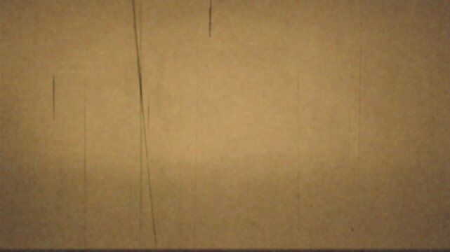 Vintage film grain texture with vertical scratches and subtle dust motes, sepia tone, reminiscent of old cinema or retro analog recording