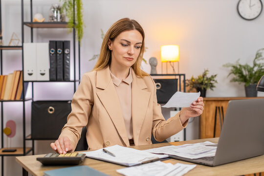 Middle-aged businesswoman at home office sorts receipts uses calculator balances budget reviews data smiles satisfied. Freelancer girl at table signs contract checks terms adds note and saves copy log
