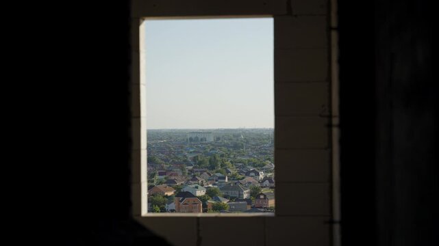 City view through window opening in unfinished building