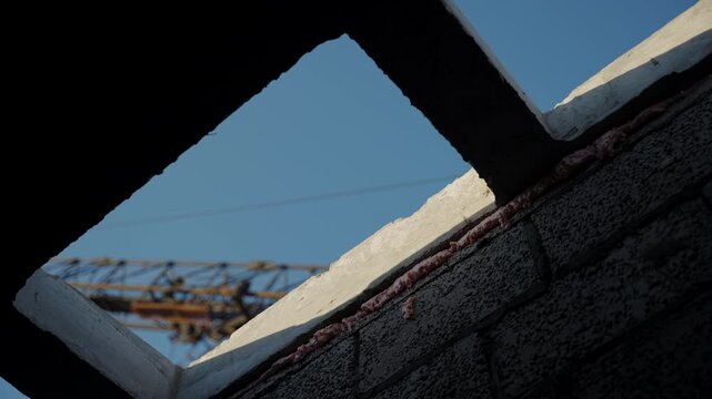 Roof openings and crane above unfinished concrete block building
