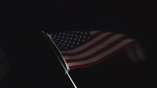 Solomons, Maryland USA A US flag flies at night from a pier. 