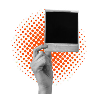 A hand holds a blank photo frame in front of a colorful dotted background. The frame is empty and ready for a picture. This scene captures a moment of potential.